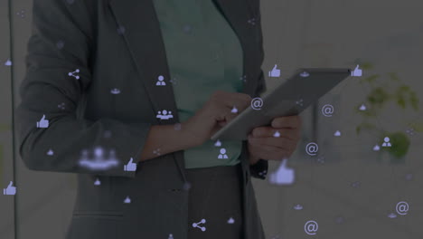 Animation-of-network-of-connections-with-icons-over-caucasian-businesswoman-using-tablet