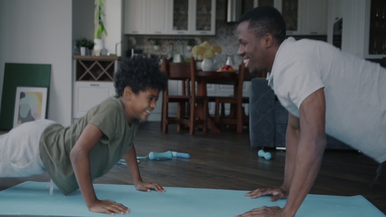 Father and Son Doing Push-Ups at Home