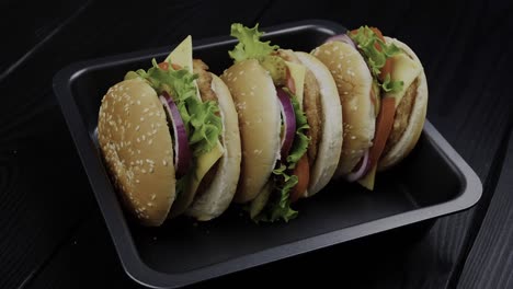 an array of burgers is displayed on a sleek black plate, illustrating the concept of culinary abundance and satisfaction
