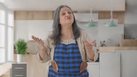 Happy-Indian-aged-housewife-talking-to-the-camera