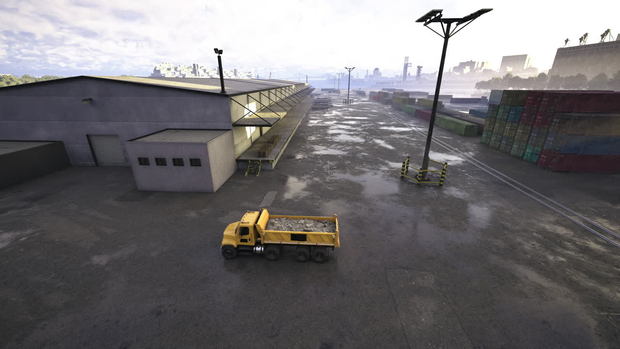 Construction truck driving near warehouse in industrial area during daytime