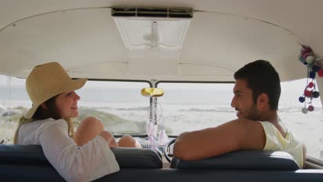 young adult couple talking in a camper van 4k