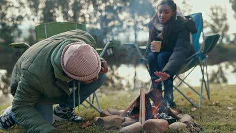 Fire,-camping-and-couple-in-a-forest-relax