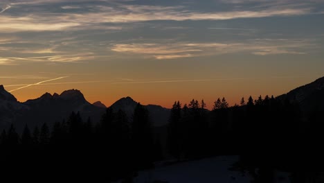 silhouetted mountains against a fiery sunset sky in amden, weesen, glarus, switzerland