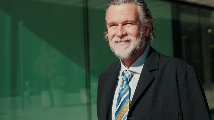 Smiling Businessman Walking Outside Modern Office