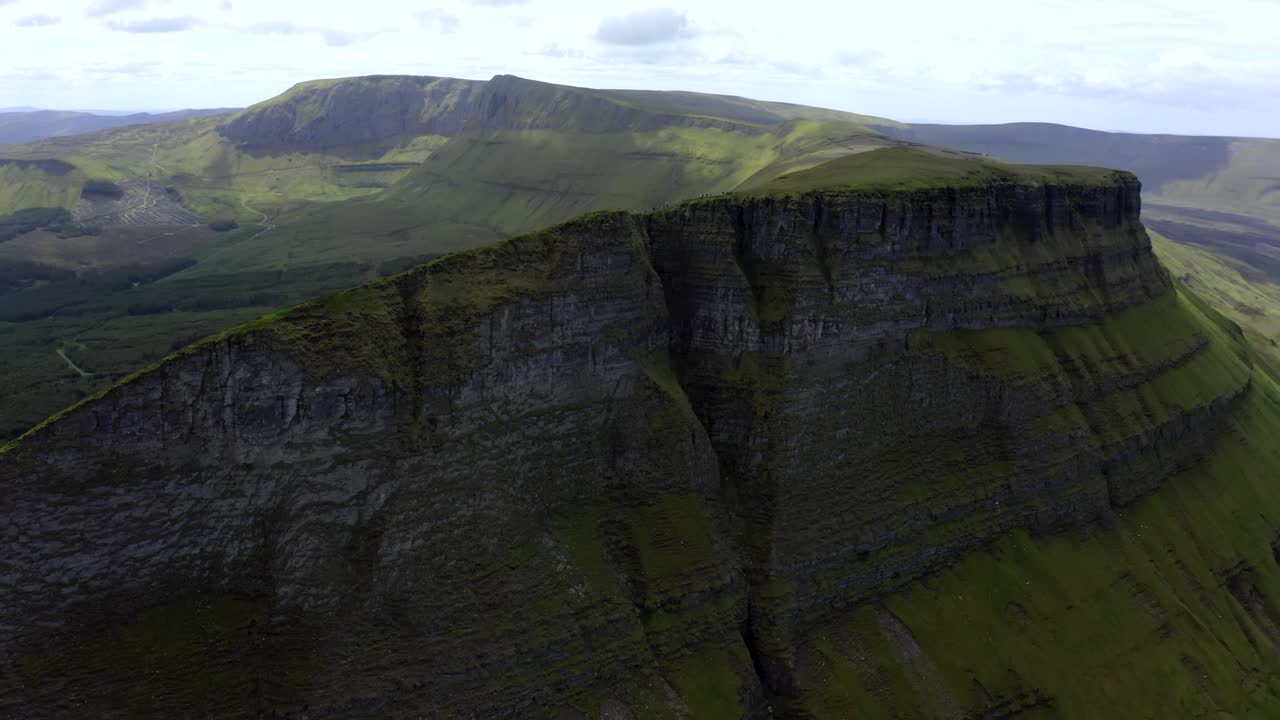 Benwiskin Mountain Sligo, Ireland, June 2021. Drone gradually orbits the cliffs revealing a group of hill-walkers with Benbulbin and the Gleniff Horseshoe mountains in the background.