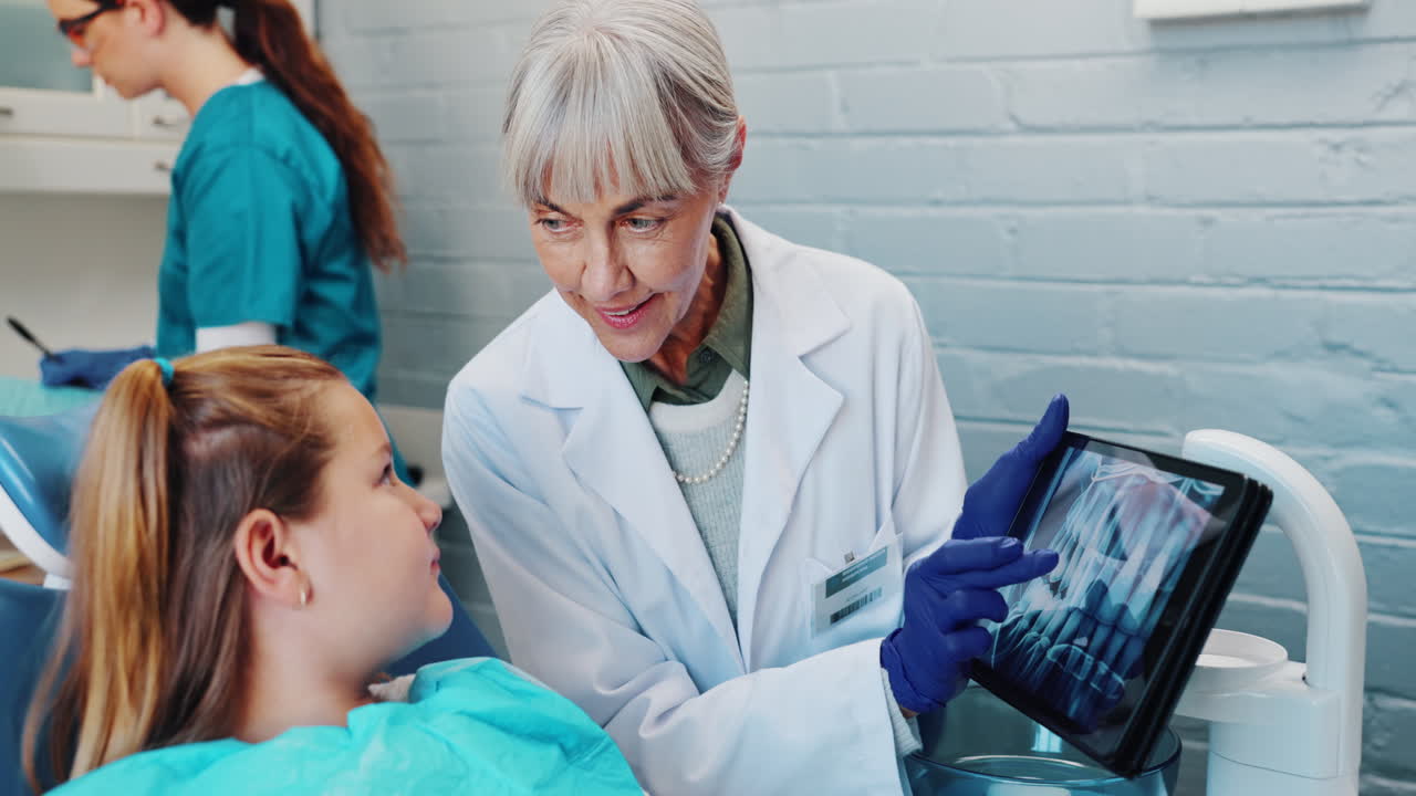 Dentist showing x-ray to patient