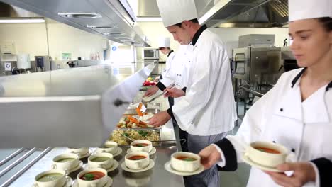 team of busy chefs working at the order station