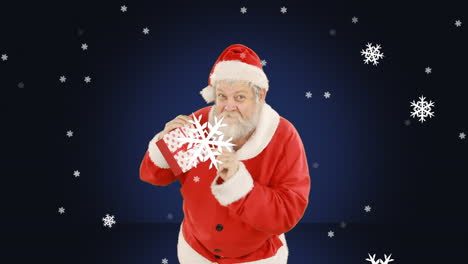 animación de santa claus presente con nieve cayendo sobre un fondo azul