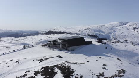 ascending tilt down aerial voss resort ski destination at mount hangurstoppen - clear sunny day at end of season - norway