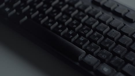 hand typing on a black keyboard