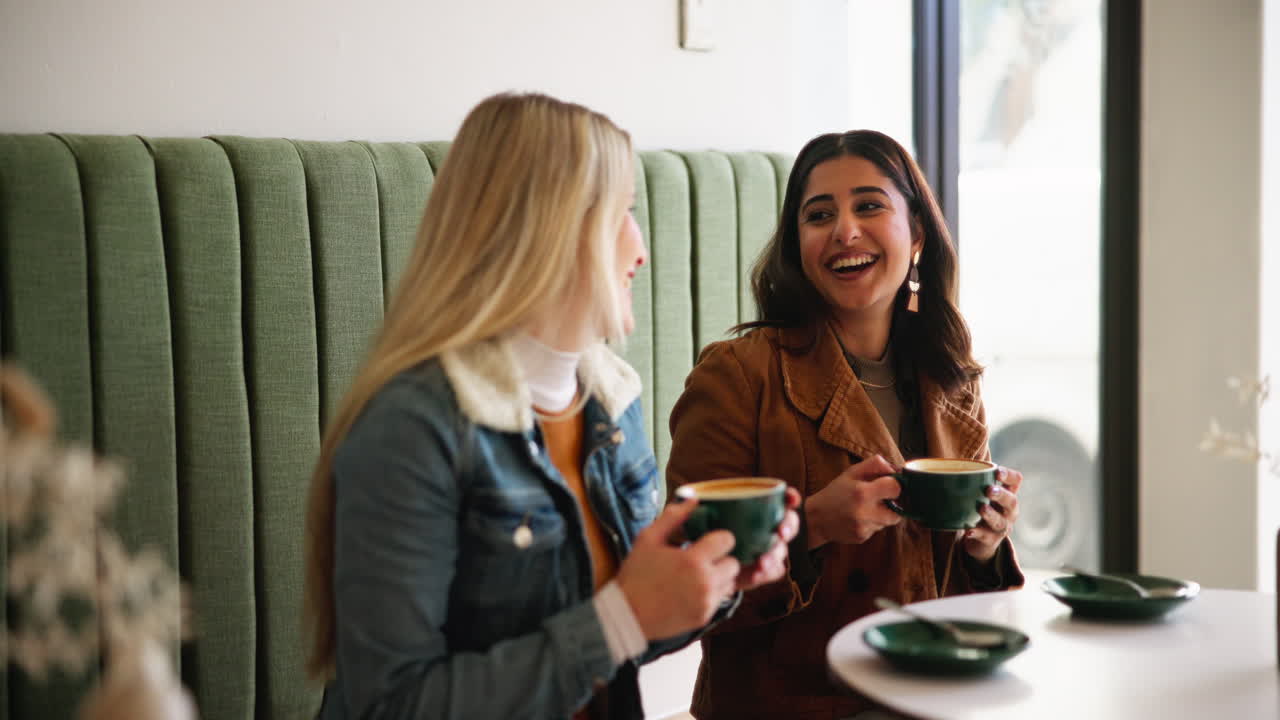 Two friends enjoying coffee at a cafe
