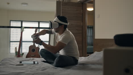 man holds vr controller, focused on intense gaming in modern living room setup