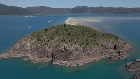 drone flyby over pristine langford island with long white sand spit exposed during low tide in whitsundays, queensland