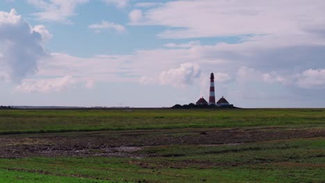 wide shot from a daylight timelapse of a lighthouse near the north sea
