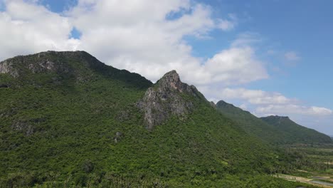 Limestone-mountain-with-a-towering-rock-jutting-out-as-the-footage-slides-to-the-right