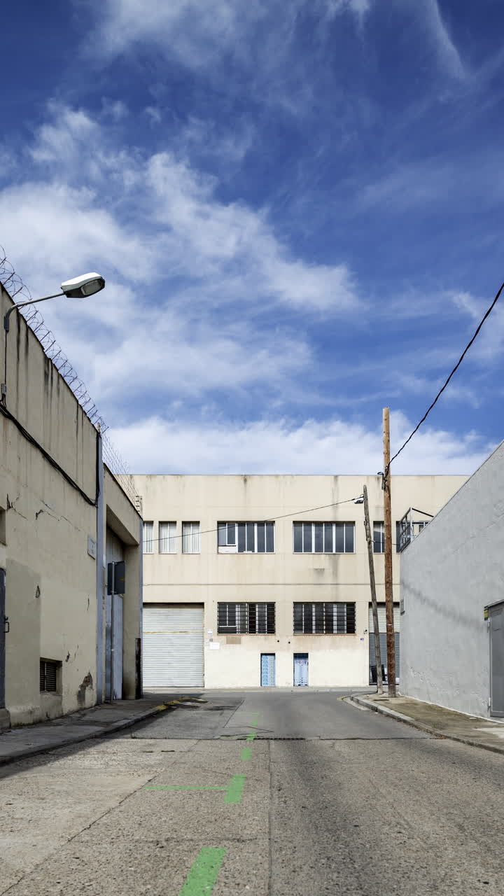 Old factory and industrial complex with passing clouds in vertical