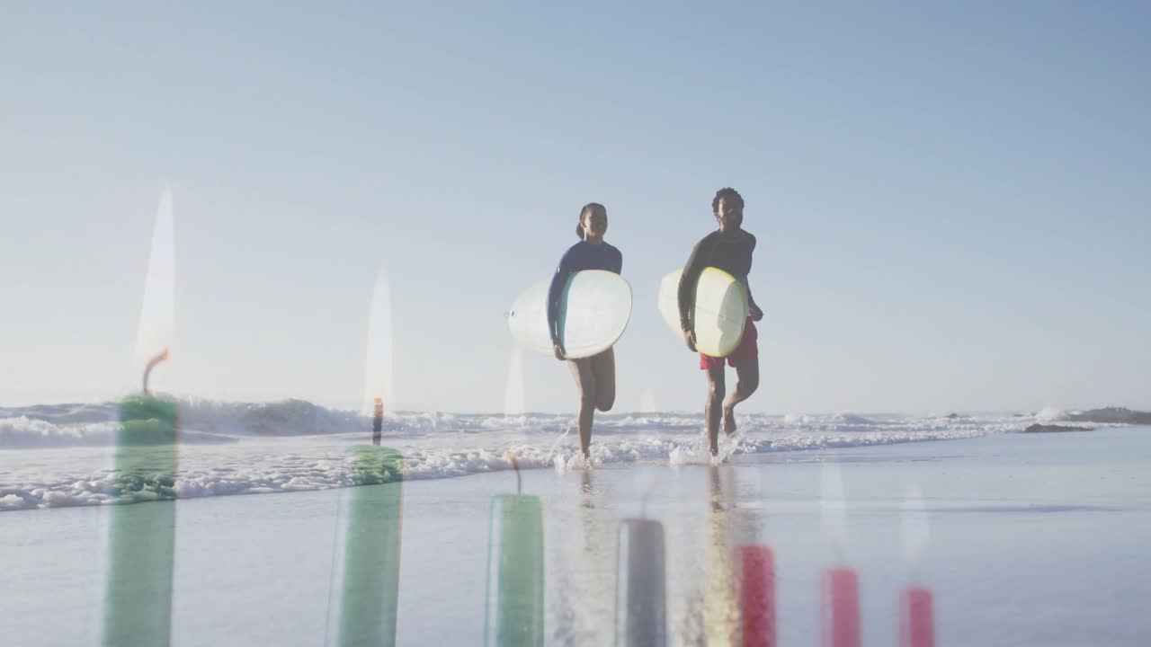 Walking on beach, surfers with animation of candle flames in background