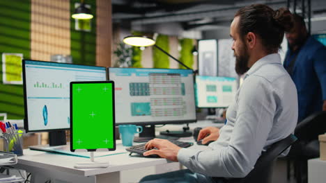 vertical video business consultant examining forecasts with chroma key on tablet