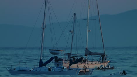 slow motion shot of sailboats floating calmly off santa barbara coast during twilight