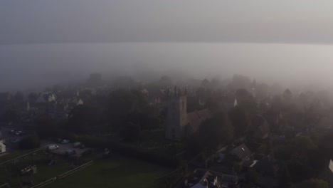 drone shot orbiting islip church in mist 01