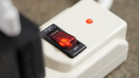 power strip with orange-red light flickering. closeup