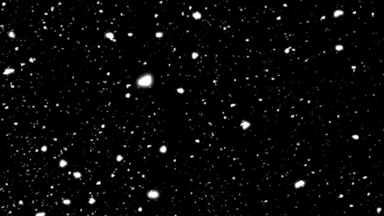 Copos de nieve cayendo sobre fondo negro. Animación en bucle