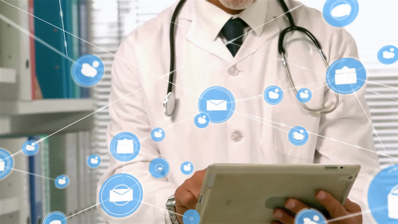 Animation of email and message network over happy caucasian male doctor using tablet