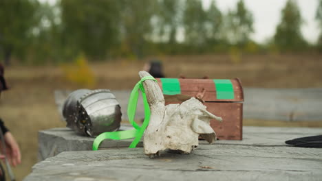 women put medieval artifacts on table in medieval village