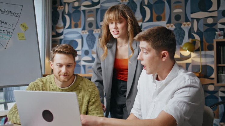 Young partners cooperating office boardroom discussing business ideas closeup