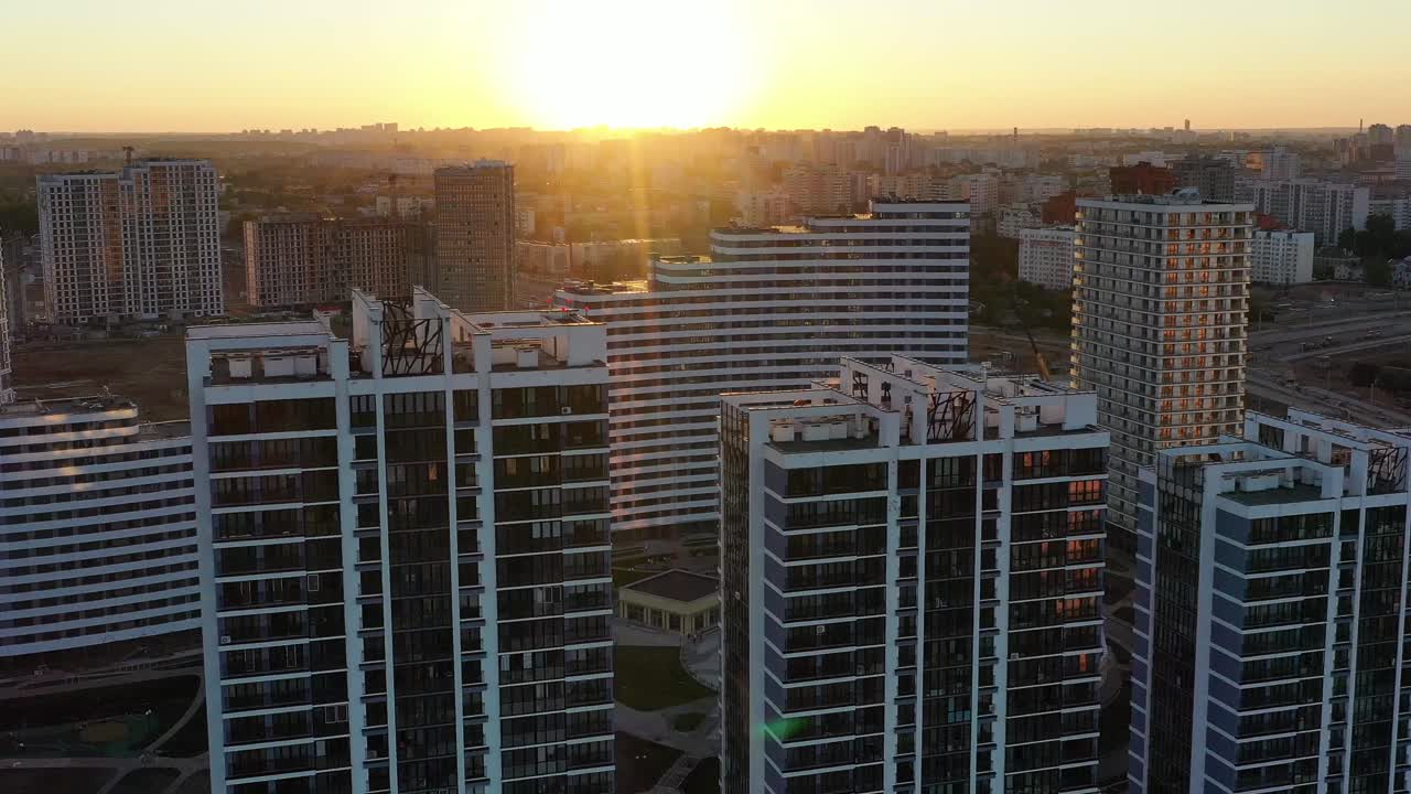 Aerial view of modern city buildings during sunrise or sunset