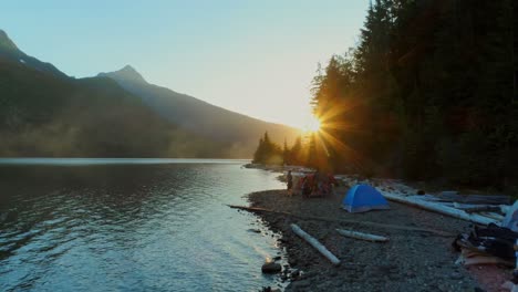 Panning-shot-of-friends-enjoying-night-at-the-side-of-a-lake.