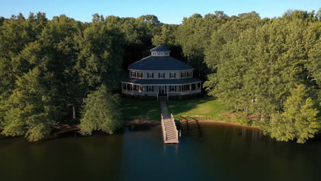 unique round lake house with private pier surrounded by forest