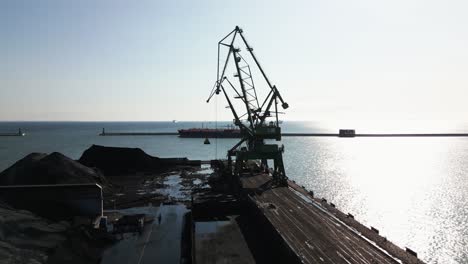 two large cranes in a container ship port, harbor, drone