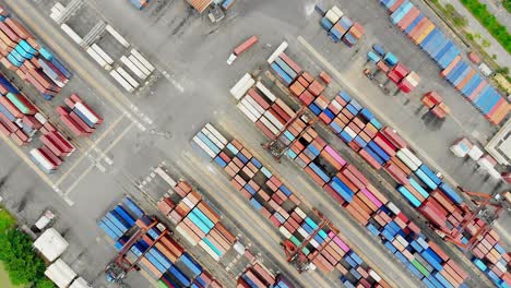 stacked red and blue containers at terminal, global logistics