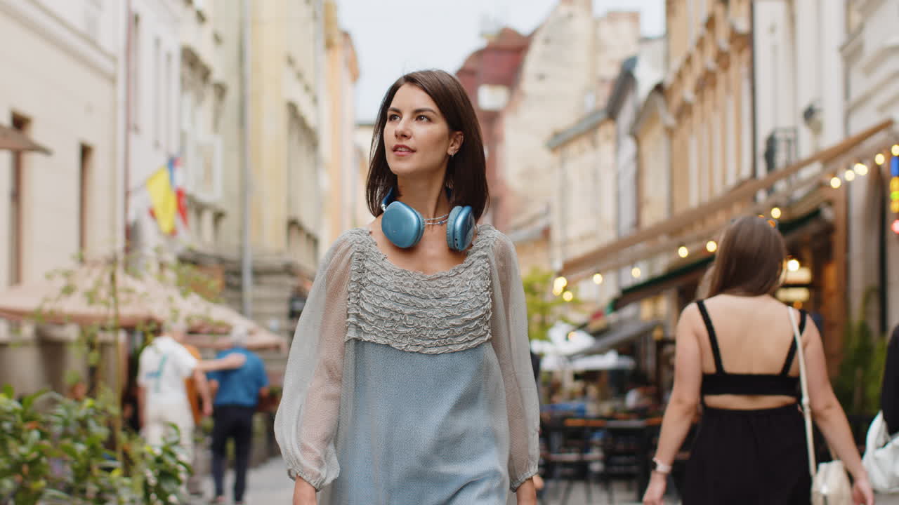 Portrait of young woman girl tourist walking in urban city street smiling having positive good mood