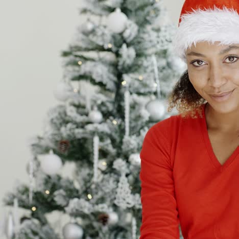 happy festive young woman in a santa hat