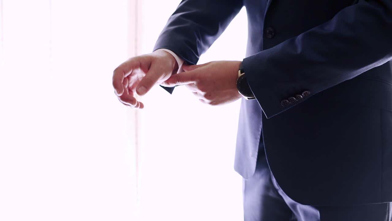 Man in a suit getting dressed