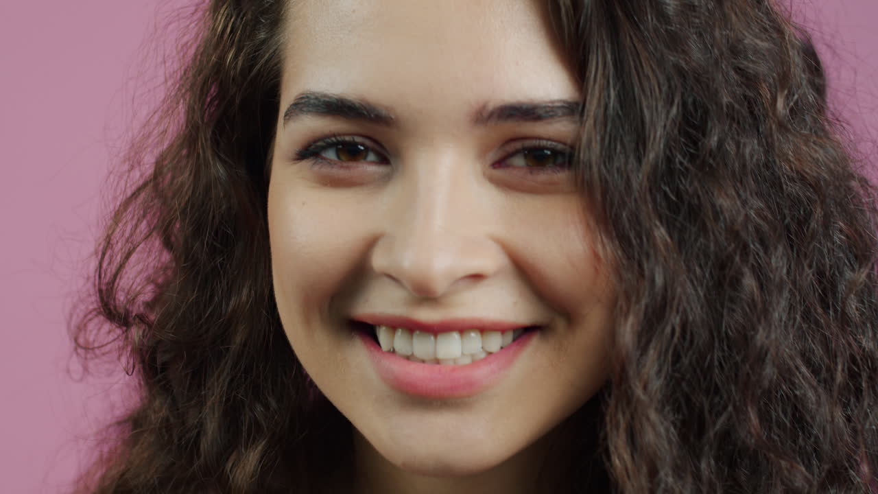 Smiling young woman with curly hair