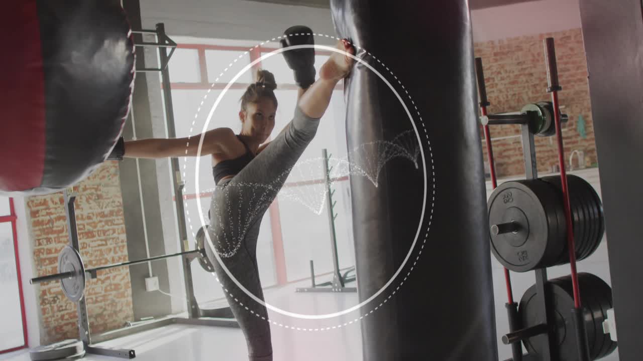 Woman guarding, overlay appearing, punching, kicking heavy bag, overlay showing hits, fitness