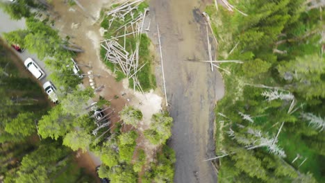 Top-down-circling-aerial-view-above-a-large-river-and-picnic-area-among-the-trees-near-Yellowstone-in-Wyoming