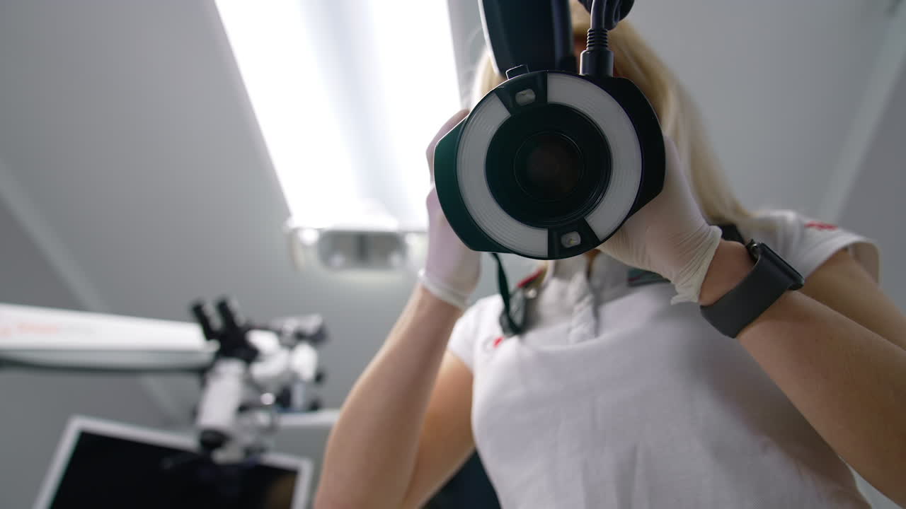 Dentist and patient in dentist office. Dentist works with female patient in dental office