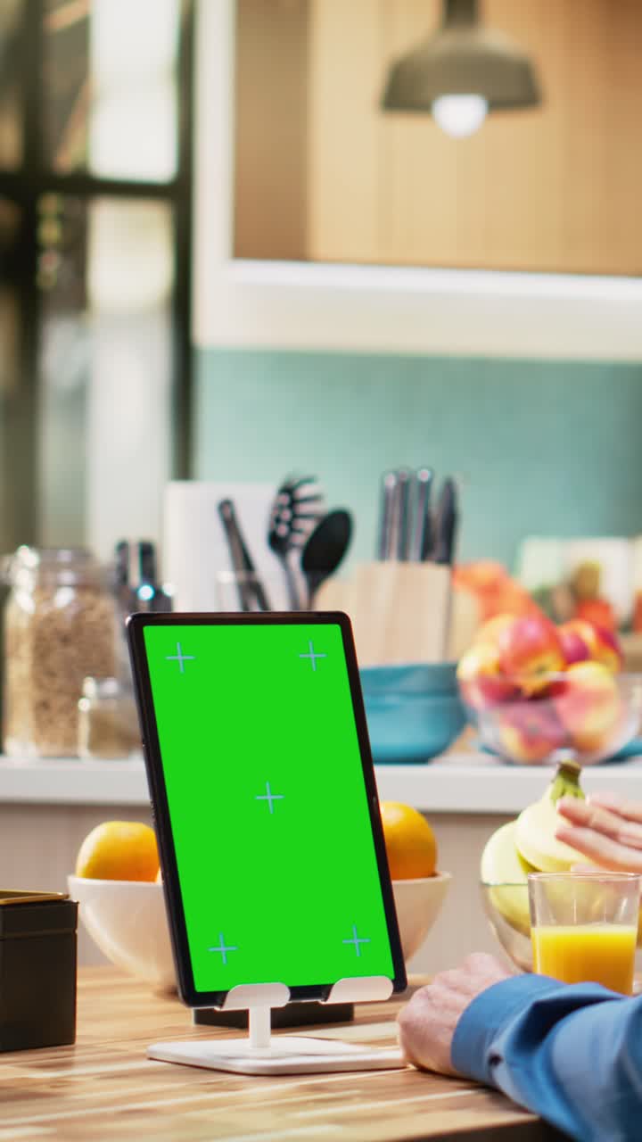 Vertical Video Vertical chroma key tablet with senior man enjoying morning routine