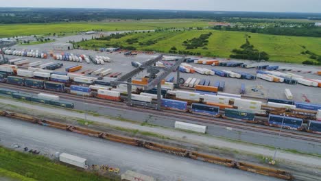 4k drone video of trains and trucks at csx intermodal train yard in winter haven, fl