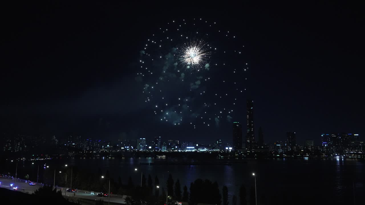 Firework display Exploding Above Han River with View of Yeouido 63 Building Skyscraper During Seoul International Firework Festival 2024