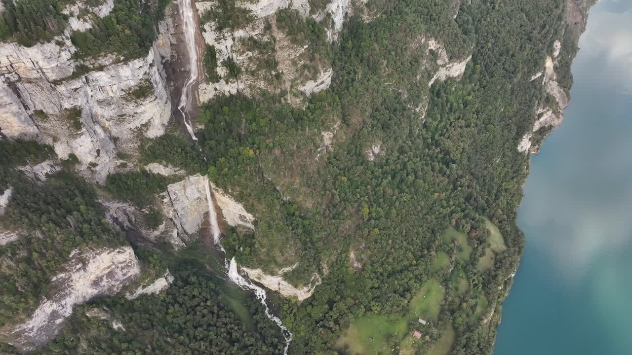 Aerial View of Stunning Waterfall Cascading into a Turquoise Lake