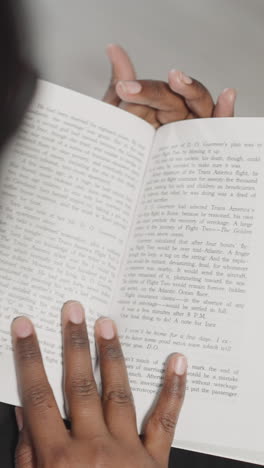 indian woman reads interesting history book flipping pages on blurred background. female student gets prepared for coursework at college closeup