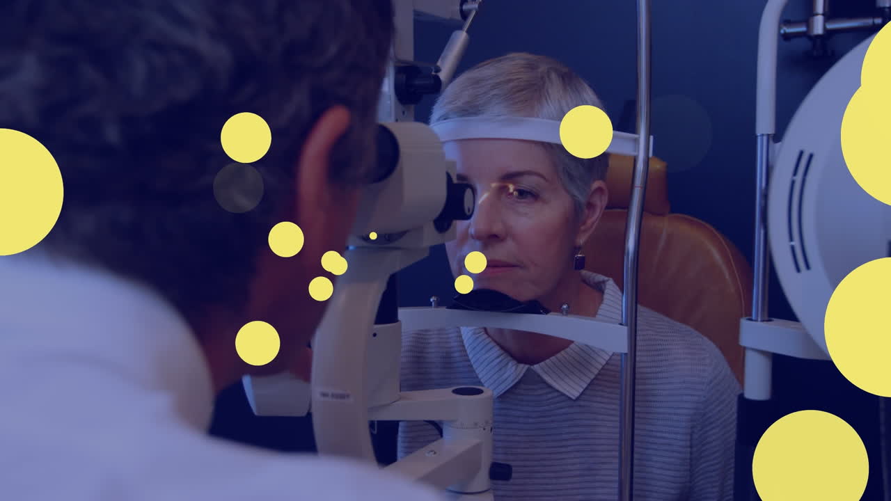 animación de puntos amarillos que se mueven sobre la mujer caucásica durante el examen de la vista