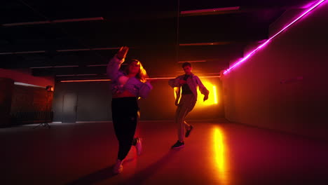 couple dancing in a neon lit studio