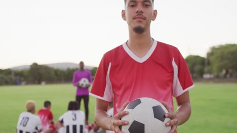 video of biracial football player on field with ball